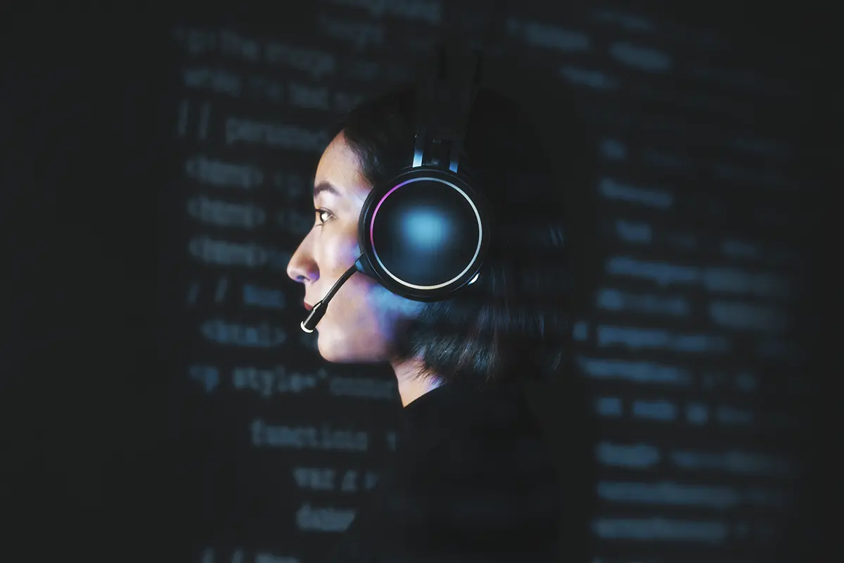 A tech specialist working with code, representing the AI and Natural Language Processing tools used to automate customer support systems.